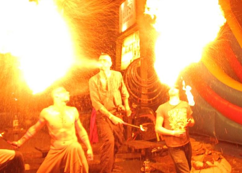 Creative Flame fire performer breathing fire during a live event